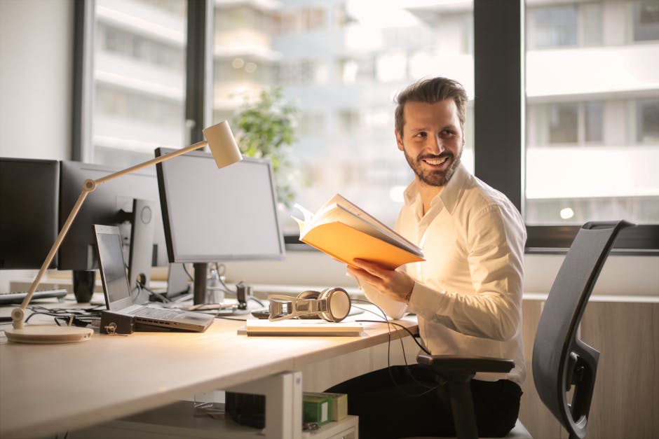 self-care ideas for busy professionals - A relaxed businessman enjoying a break in his bright, contemporary office environment.
