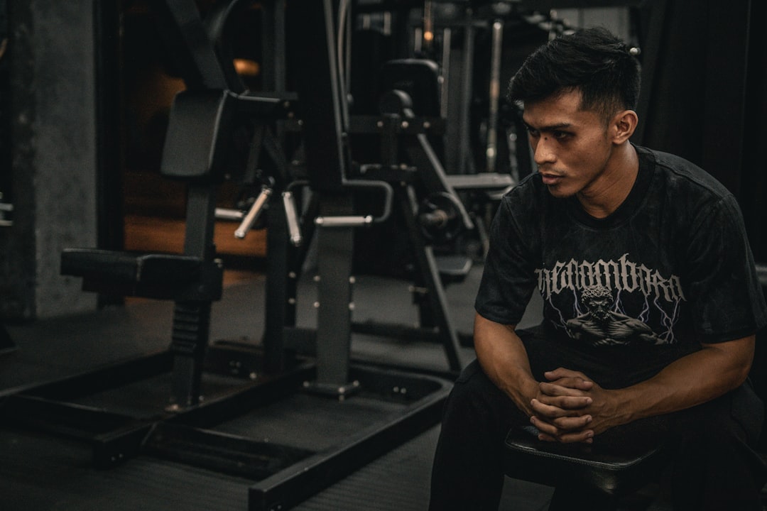 accountability apps - A man sitting on a bench in a gym