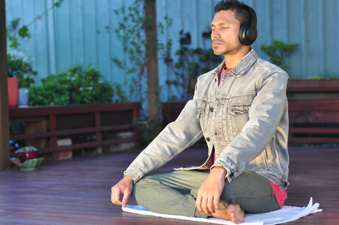 build a meditation practice from scratch - a man sitting on a table wearing headphones