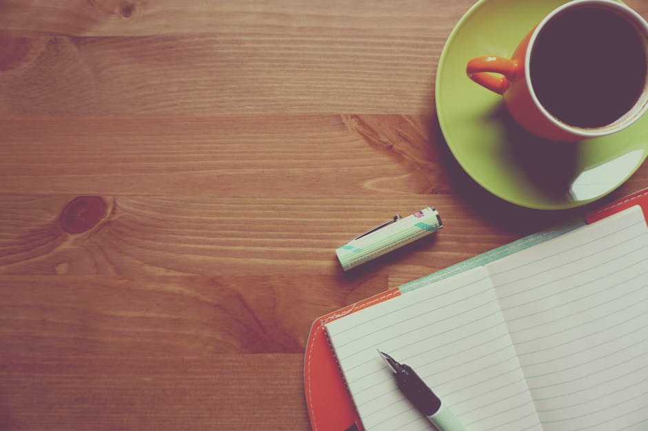 journaling for mental health benefits - A warm and inviting workspace featuring a cup of coffee, journal, and pen on a wooden table.