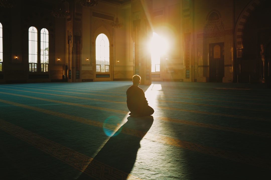 morning routine habits for better mental health - Person sitting in a large, sunlit hall