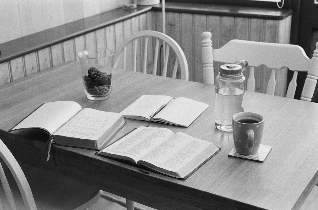 morning routine habits for better mental health - a wooden table topped with a book and a cup of coffee