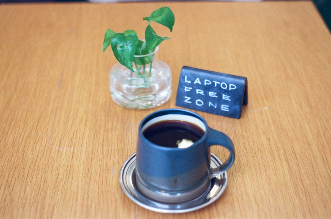 screen time management and digital detox strategies - A mug of coffee with a plant and sign