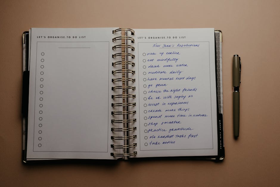 wellness news April 2026 - Open planner with New Year's resolutions, spiral binding, and pen on warm-toned background.