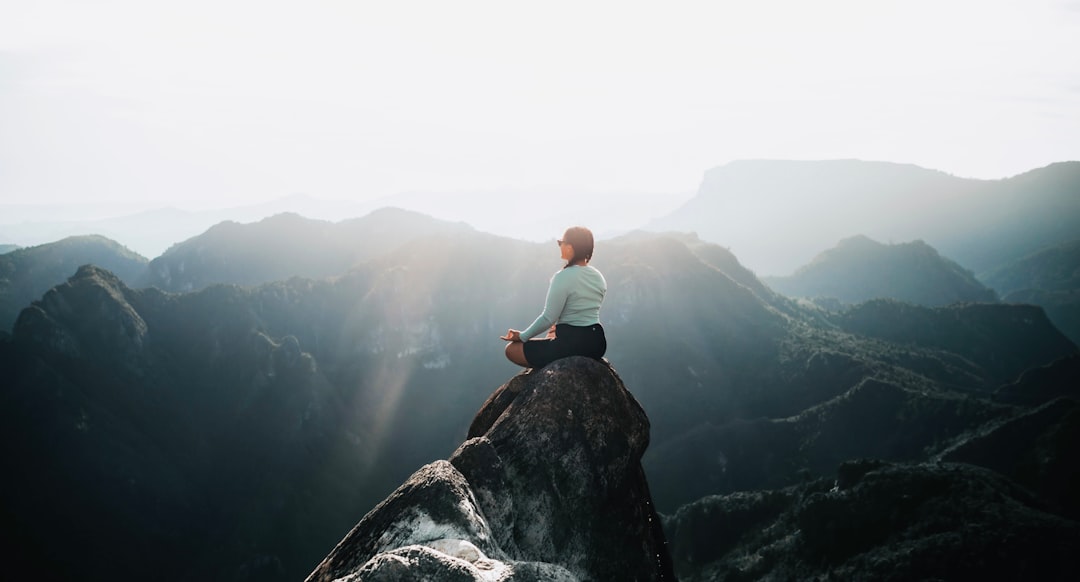 wellness news April 2026 - a man sitting on top of a large rock