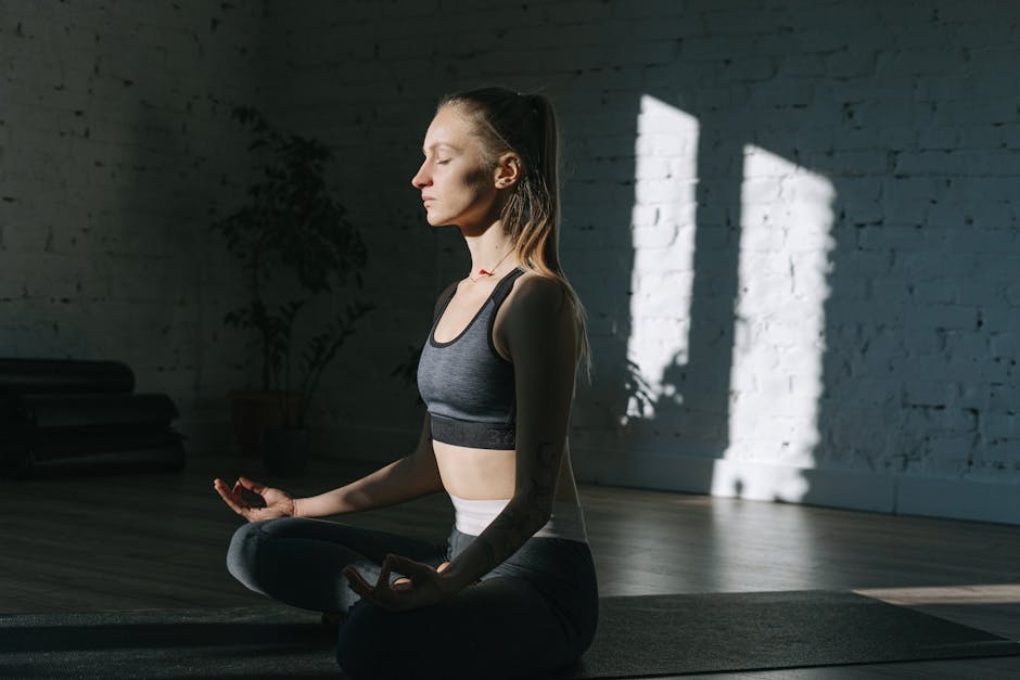 ADHD mindfulness - Woman in lotus position meditating indoors, embracing mindfulness and tranquility.