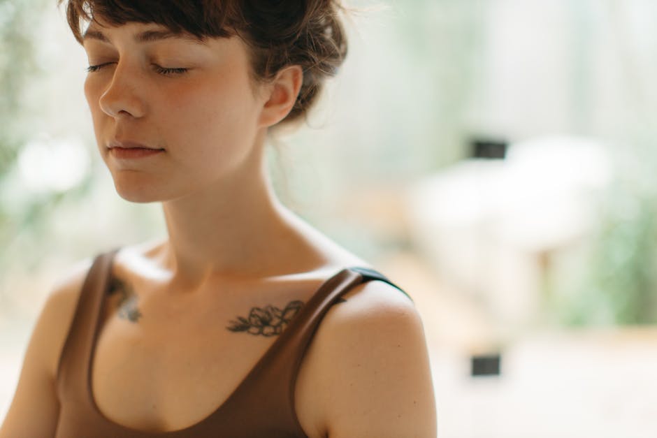 mantra meditation - Woman with closed eyes meditating indoors, symbolizing tranquility and focus.