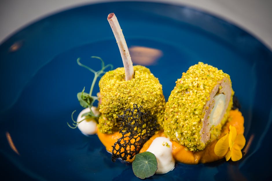 mindful eating - Exquisite lamb rack with pistachio crust, plated on a vibrant blue dish, showcasing fine dining artistry.