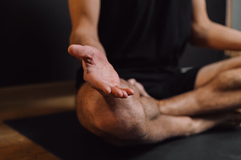 4-7-8 breathing - Crop unrecognizable barefoot male sitting with crossed legs on sports mat during stress relief meditation session