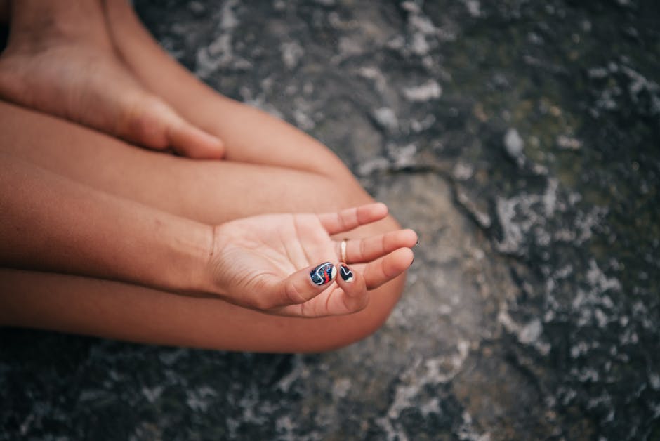 progressive muscle relaxation - Close-up of a hand in gyan mudra, symbolizing peace and mindfulness during meditation.