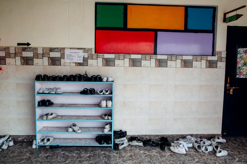 friction reduction - A school hallway with a colorful wall and neat shoe rack arrangement.