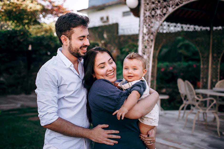 mindful parenting - A smiling family of three enjoys an outdoor moment in a garden setting.