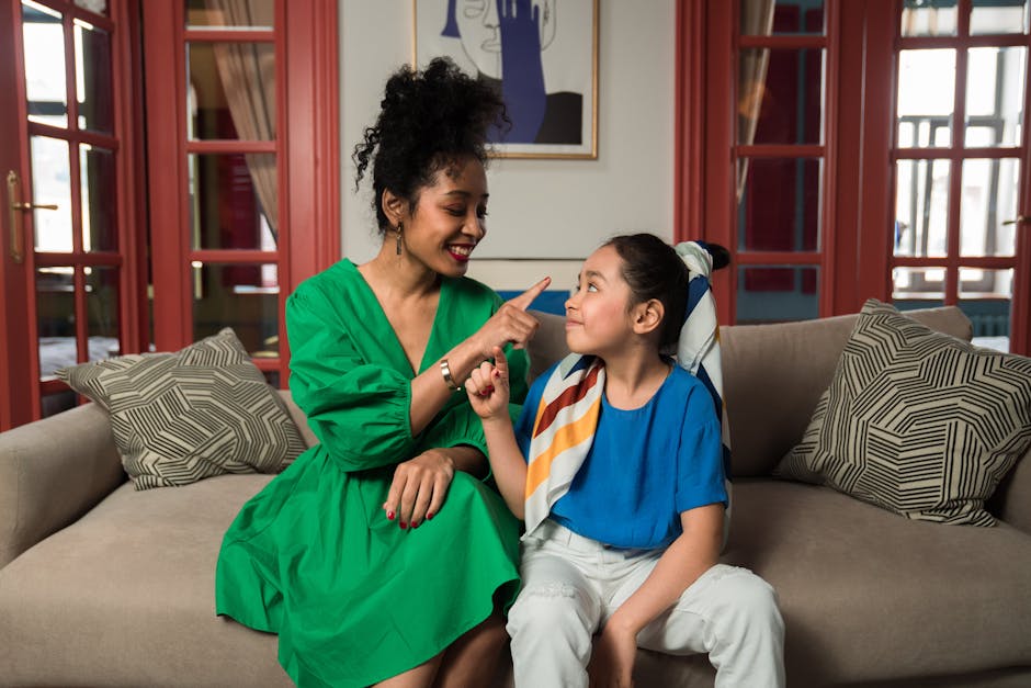 mindful parenting - A mother and daughter share a joyful moment indoors, showcasing family bond and happiness.